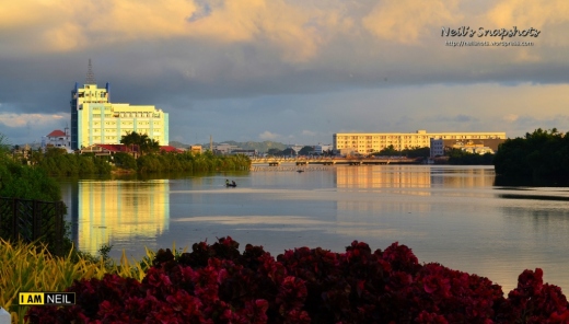 The setting sun casts a golden glow upon Iloilo, the beautiful city by the river.